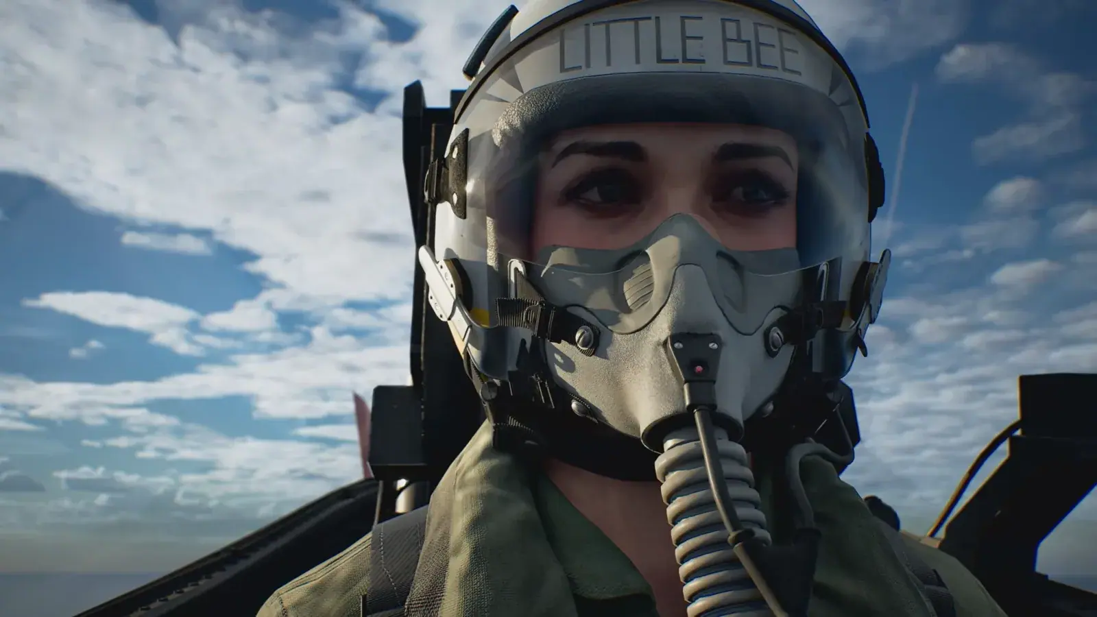 Kate Evans in a fighter cockpit wearing her flight helmet and oxygen mask